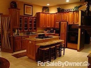 Kitchen w/ Granite Countertops & Island : Natural Cherry cabinets. Tuscan-inspired granite. Jenn-Air