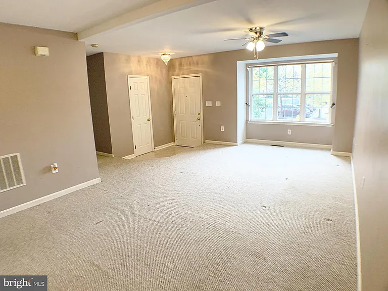Main level: Living room with entrance, half bath and open dining space