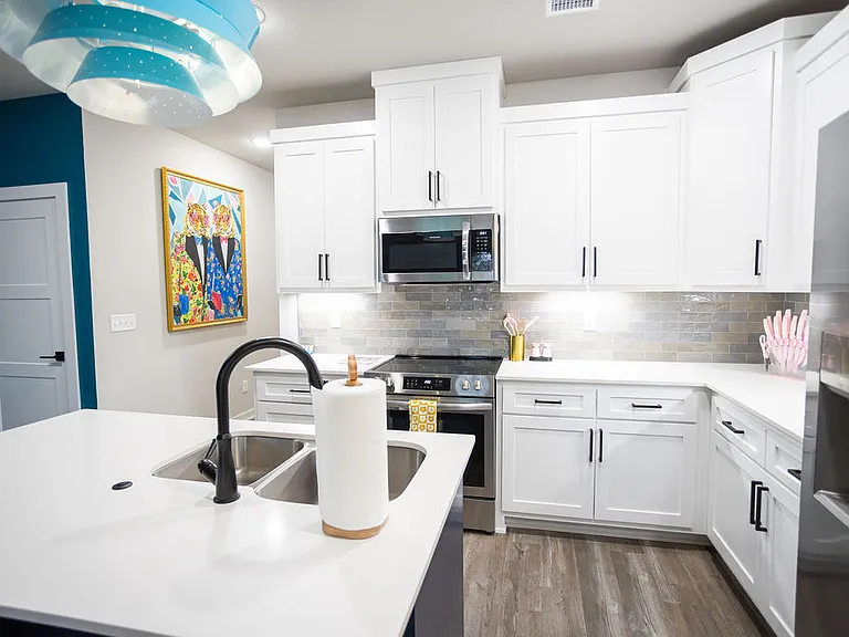 Kitchen has plenty of storage and the door on the left leads to a large walk in pantry