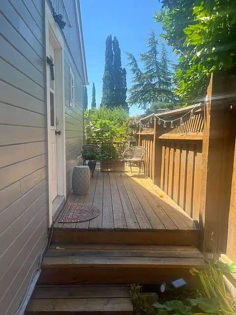 Private deck table and chairs with lighting at night. - 640 W K St #640