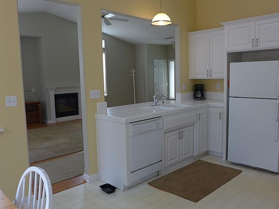 Kitchen opens to living room/dining area.
