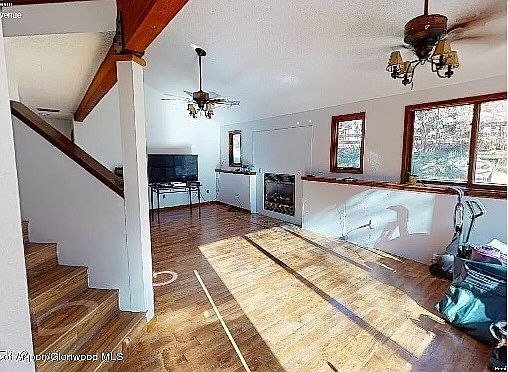 The Great Room. Has East Windows to the small front lawn. There is a wide stairwell to 2nd floor.