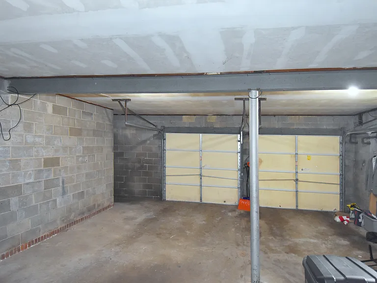 Ground floor shared garage has parking for compact car.