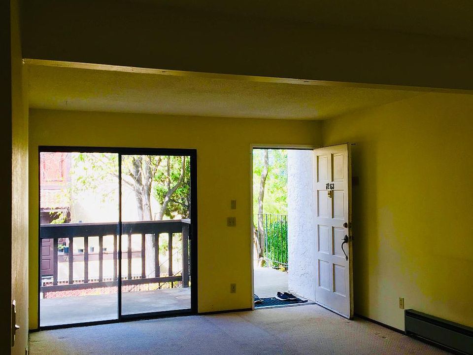 Front entrance and a large living room, with new flooring.