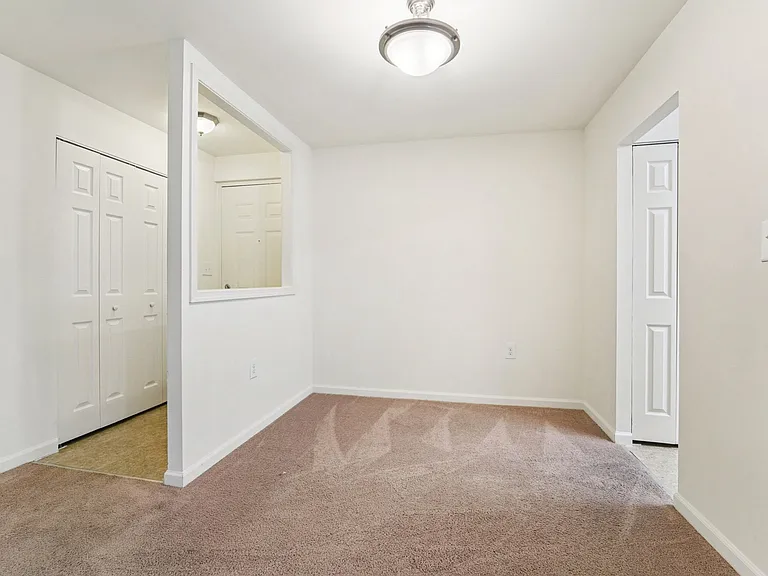 1BR, 1BA - 692SF - Foyer, Coat Closet, Dining Room and Kitchen Entrance