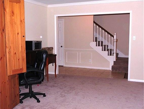 FORMAL LIVING ROOM BEING USED AS A STUDY.