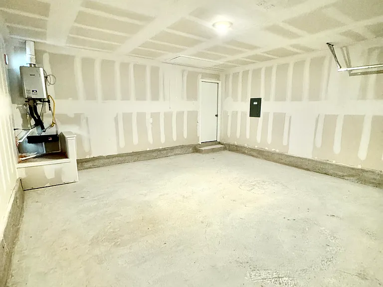 Garage with smart door opener (not shown in image), and tankless heater