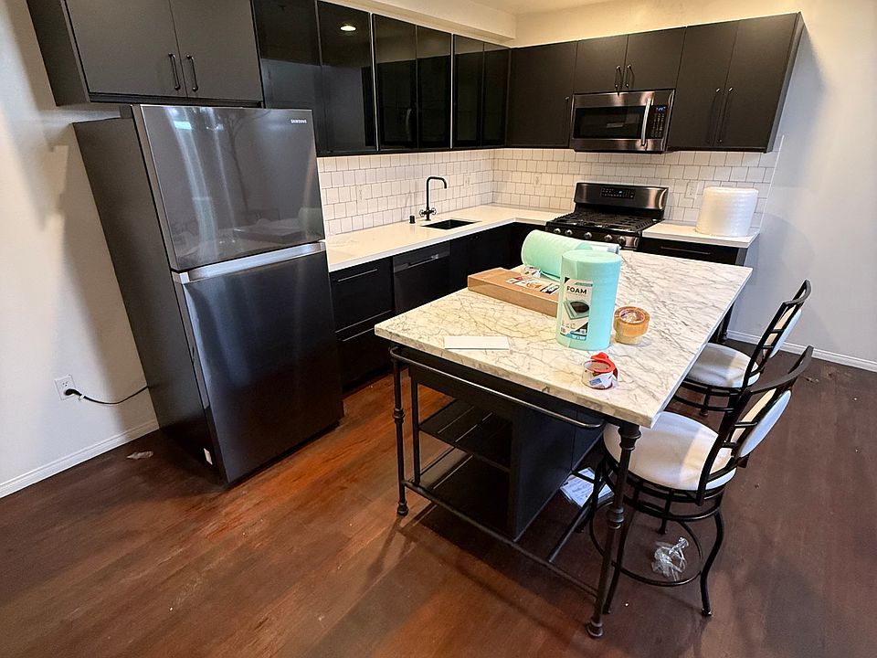 Fully updated kitchen with quartz countertops and stainless steel appliances