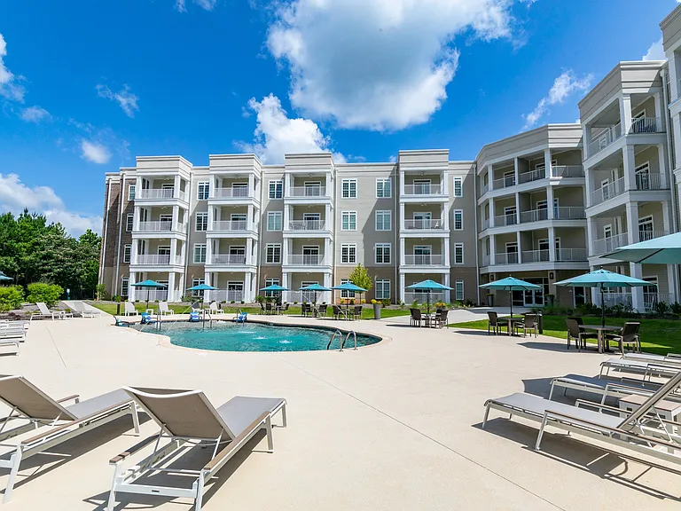 Community pool with lounge chairs