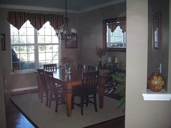 Dining room with hardwood floors and crown moldings