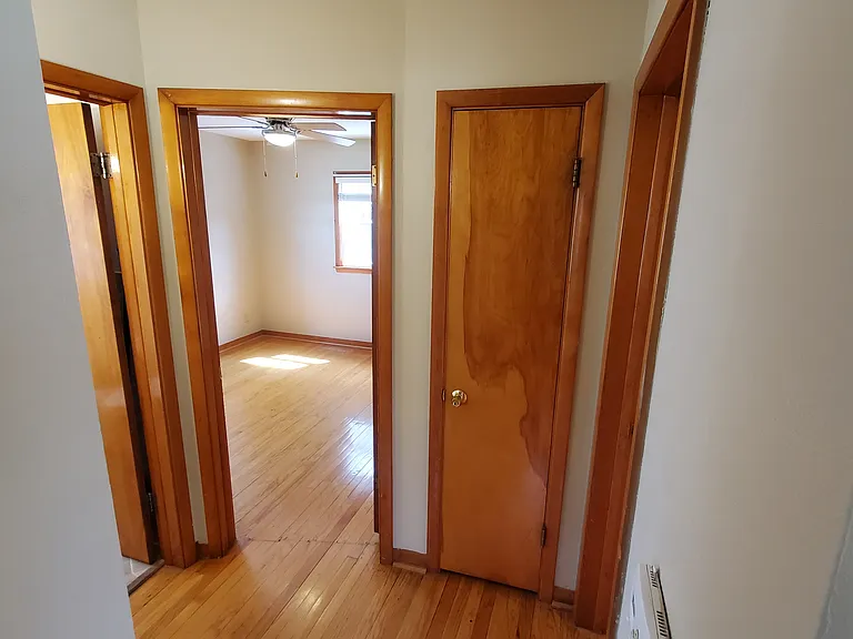 Foyer. Family room to immediate right, kitchen to immediate left. Bedroom 1 right doorway, full bath left doorway, bedroom 2 doorway one from left, linen closet small closed door. Hardwood floor.