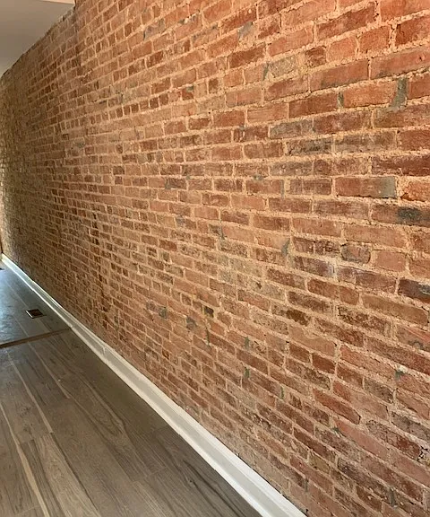 Exposed brick walls in kitchen and living room.