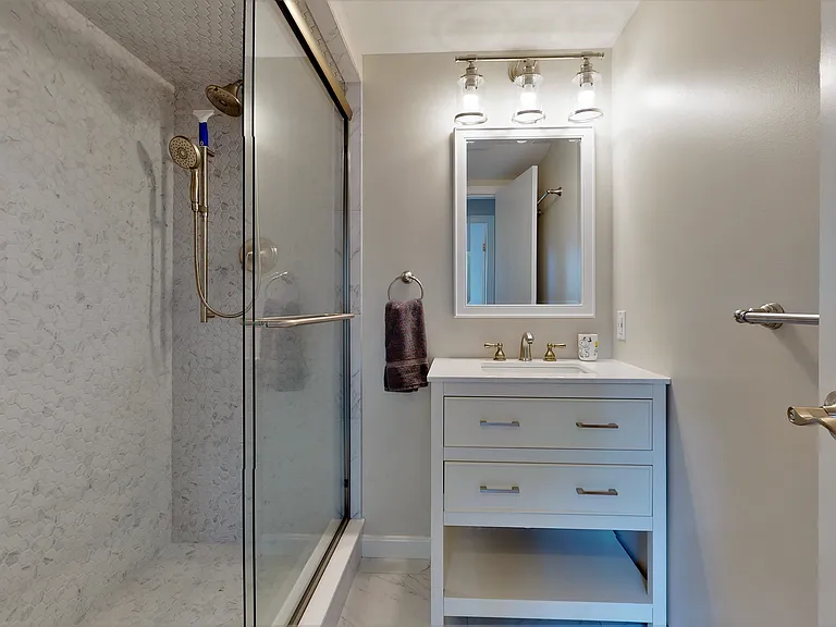 the ground floor bathroom adjacent to the bedroom with a king-size bed
