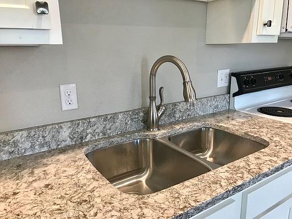Quartz countertops and stainless sink.