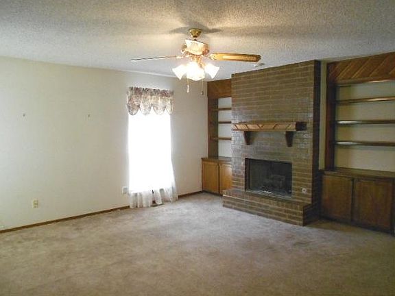 Living, fireplace, bookcases, ceiling fan