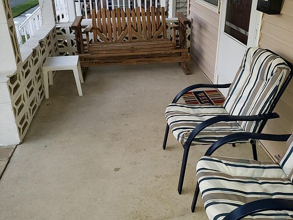Large front porch with wood loveseat rocker