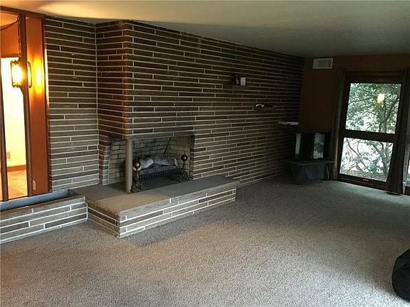 LIVING ROOM WITH LOG BURNING FIREPLACE.