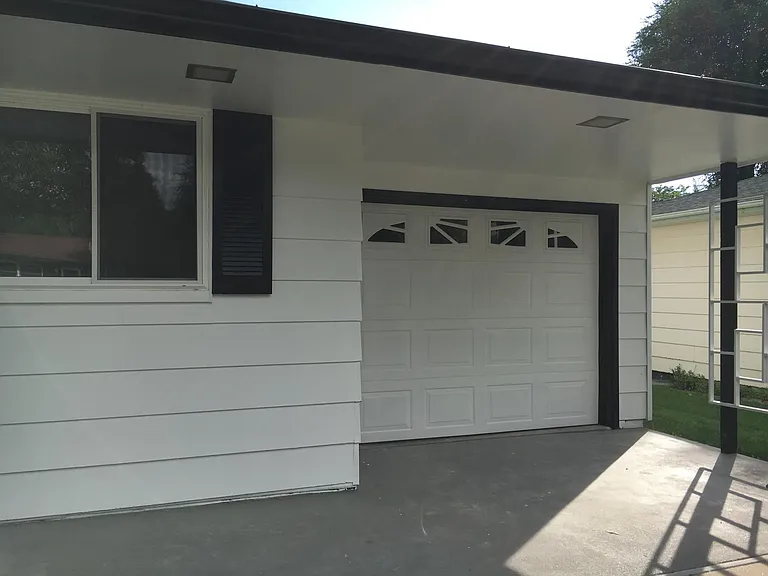Single car attached garage has a man door to the inside of the house as well as the sun room that is off the back side of the house.