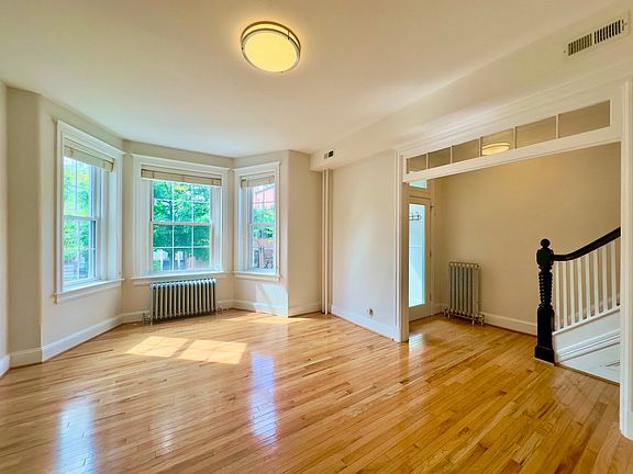 Living area, foyer, and staircase to upper level