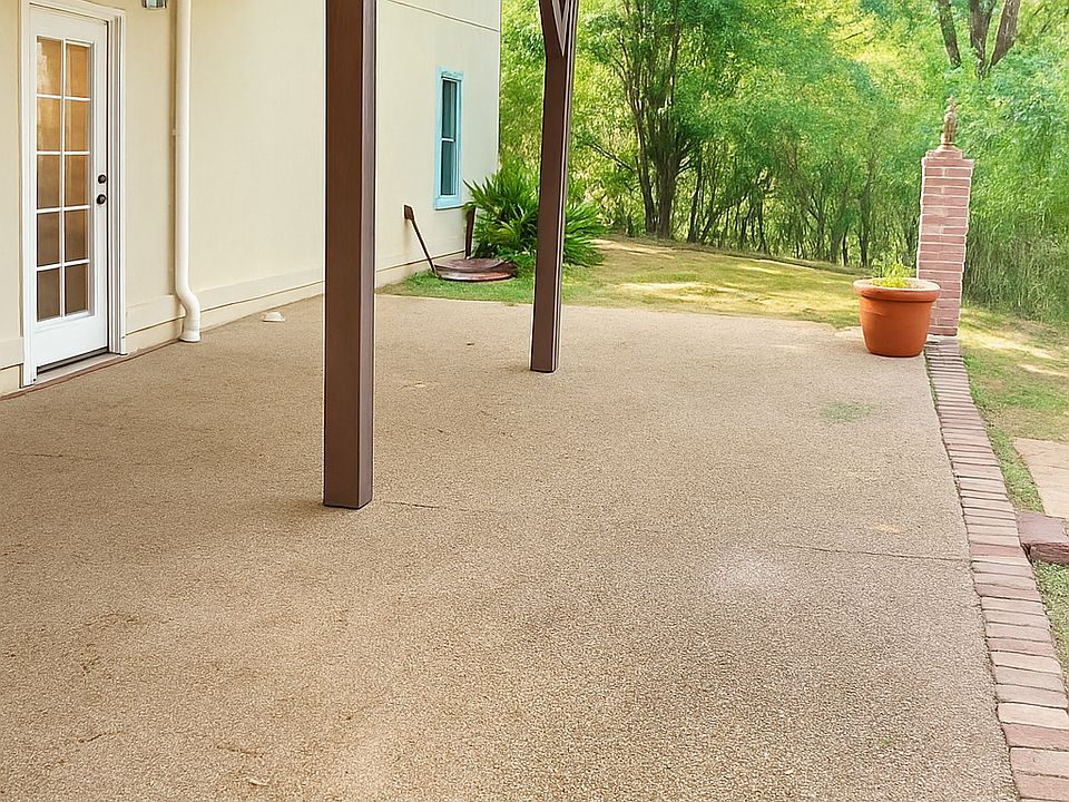 Private Patio extrance in back yard at bottom of driveway ( parking pad has 2 spaces)