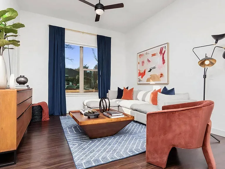 Living Room with Ceiling Fan, Area Rug, and Corner Sofa