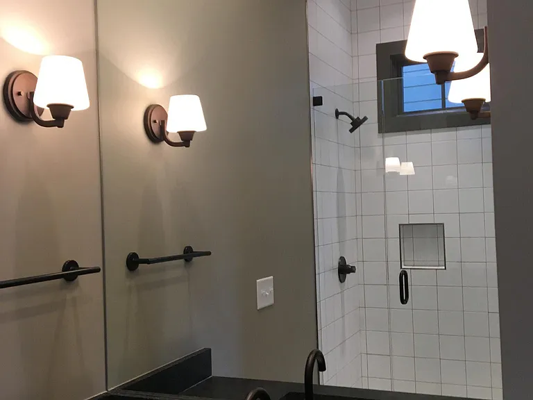 First floor primary bathroom has walk-in shower, water closet with toilet, linen closet.