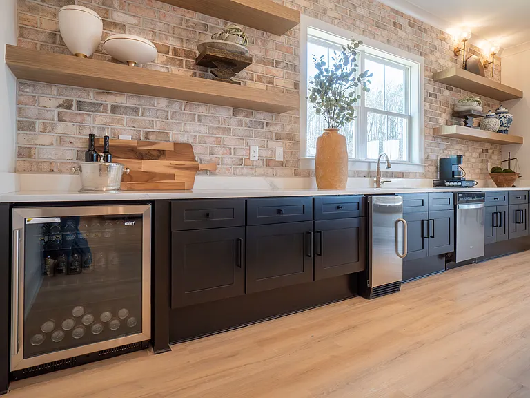 Kitchenette inside the Clubhouse with mini fridge, sink and ample counter space.