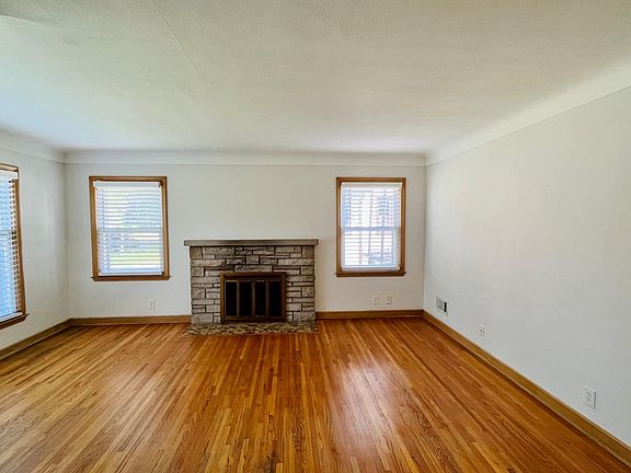 Living room with wood burning fireplace.