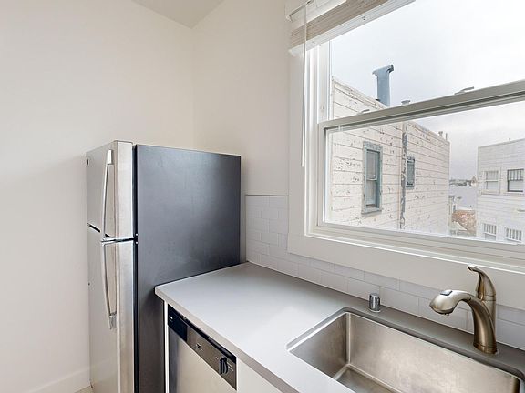 Kitchen with refrigerator and sink