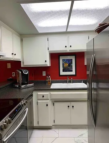 Kitchen (includes: Refrigerator, stove/range, and dishwasher, also with microwave, toaster, and Keurig coffee machine off camera)