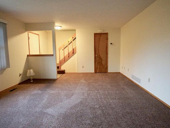 Spacious living room with new carpeting and paint.