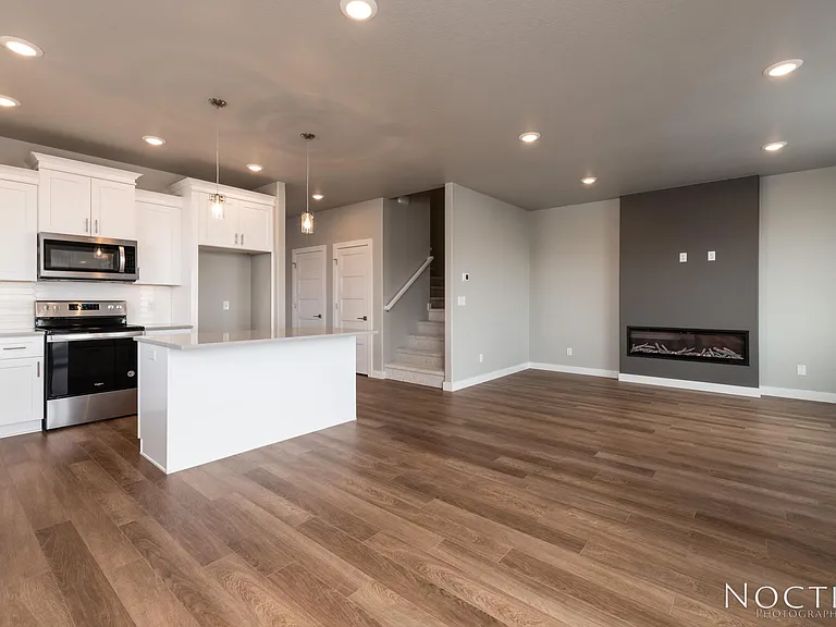 Grand open living space. (Photo of another unit with similar finishes and quality.)