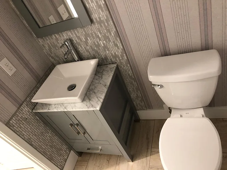 Modern design powder room on the ground floor entry level.