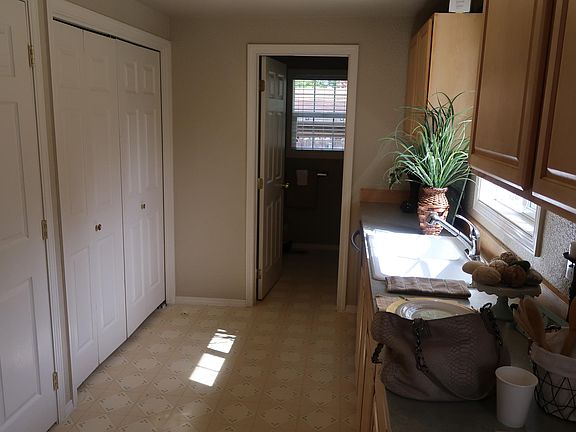 kitchen looking into bathroom at end. laundry is in doors to left.