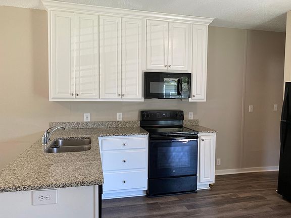 New clean, white, spacious cabinetry, granite countertops, new appliances including a dishwasher, microwave, ice maker and European style stackable washer and dryer.