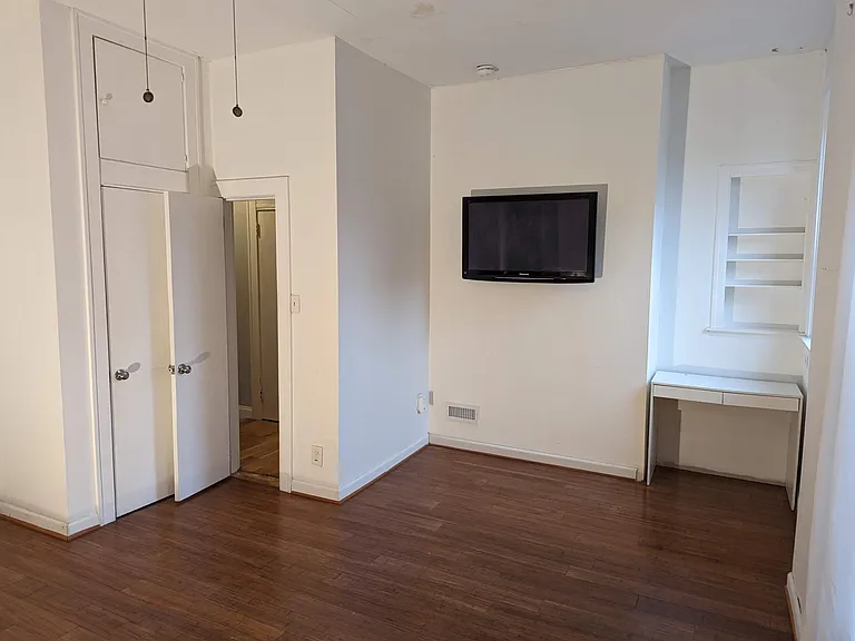 Primary bedroom with 12-foot ceilings and two large, double-level closets.