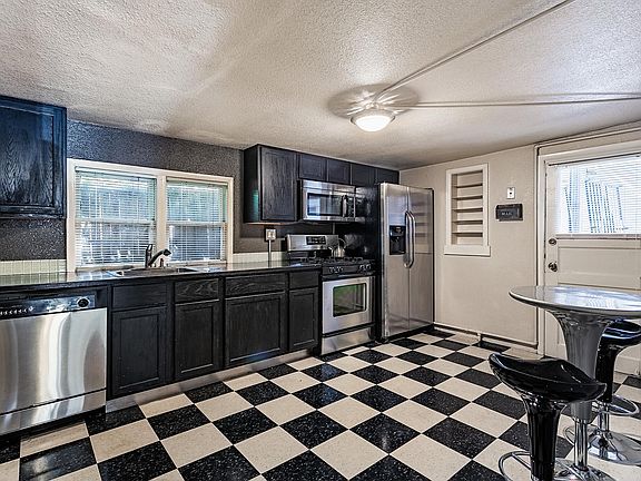 Big open kitchen with stainless COUNTER TOPS and appliances.