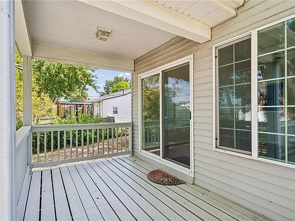 A covered back porch offers a quiet retreat overlooking the yard.