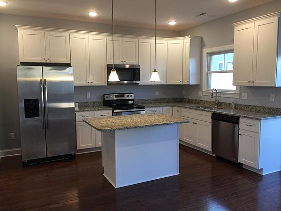 First class kitchen with stainless appliances and granite co