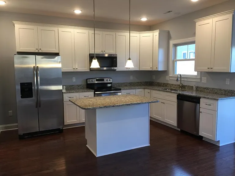 First class kitchen with stainless appliances and granite co