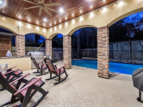 Outdoor kitchen with stainless steel fixtures and DCS grill-party lights change colors
