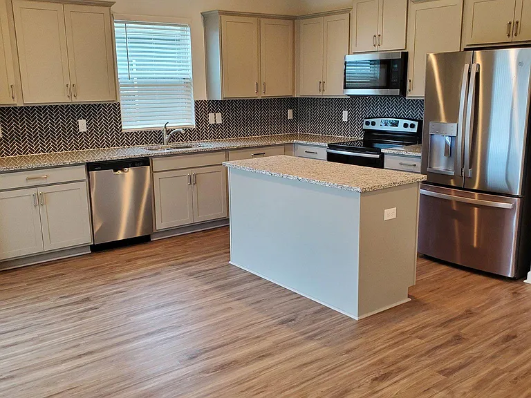 Kitchen with granite counters and tile backsplash