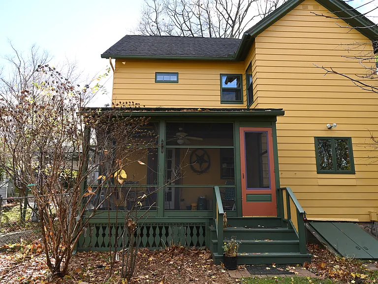 Screened in back porch overlooking fenced in yard