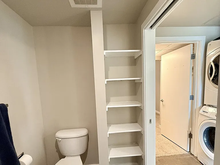 Separate toilet/shower/tub room with storage