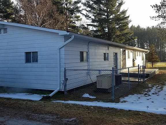 Generator and concrete deck off of the back of the house.