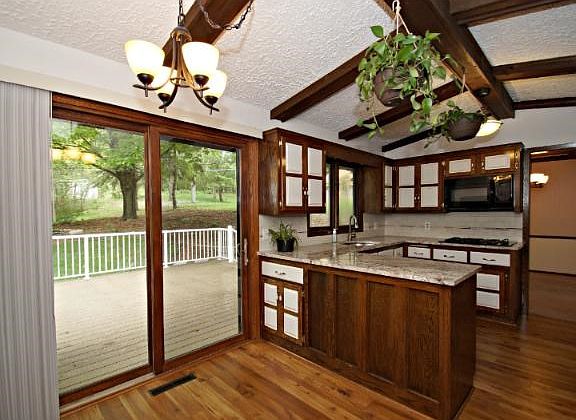 Updated lighting, new flooring and sliding door are great additions to this eat in kitchen.