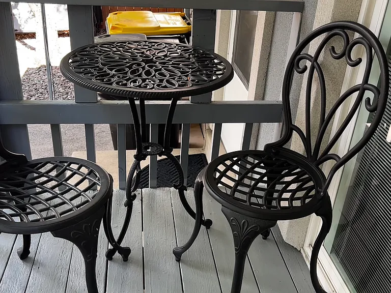 Backyard deck just off the dining area with a bistro set, perfect for morning coffee or fresh air breaks.