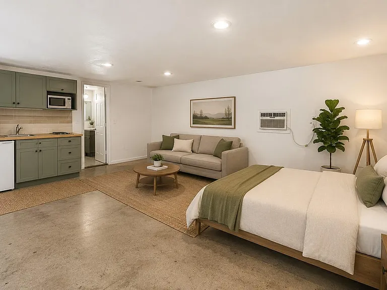 Open-concept studio with kitchenette, comfortable lounge area, and a full bedideal for easy everyday living.