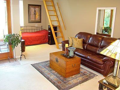 Living room and alcove showing the new paint, berber carpet, moldings