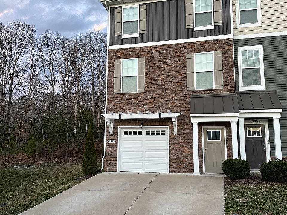 Front of house with garage and paved driveway